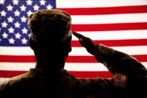 Patriotism: Military woman salutes American flag. Silhouette.